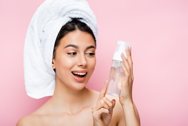 happy beautiful woman with towel on hair and cleansing foam isolated on pink - Fotó, kép