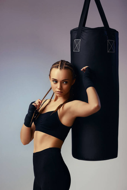 woman in sportswear with boxing bandages near bag - Fotoğraf, Görsel