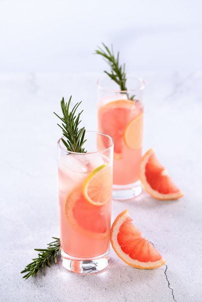 Fresh lime and rosemary in combination with fresh grapefruit juice and tequila. This cocktail is full of vibrant citrus flavors and aromatic herbs, showcasing the best of winter seasonal fruits. - Photo, Image
