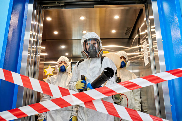 team of professional disinfectants entering the building - Foto, afbeelding