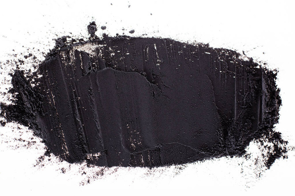 Black clay powder on white background - Foto, Imagem