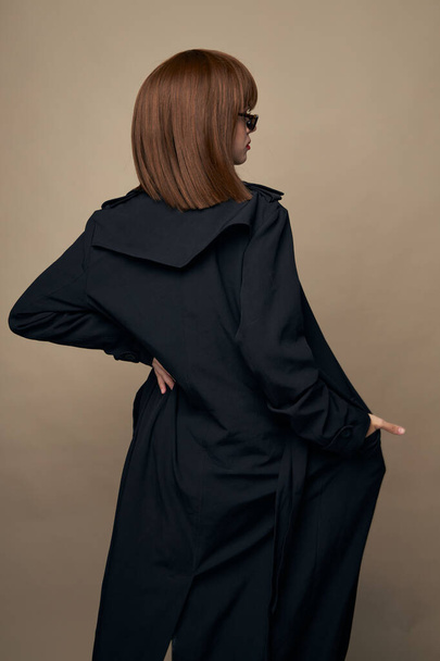 Elegant lady dark coat elegant style laughing on an isolated background - Photo, Image