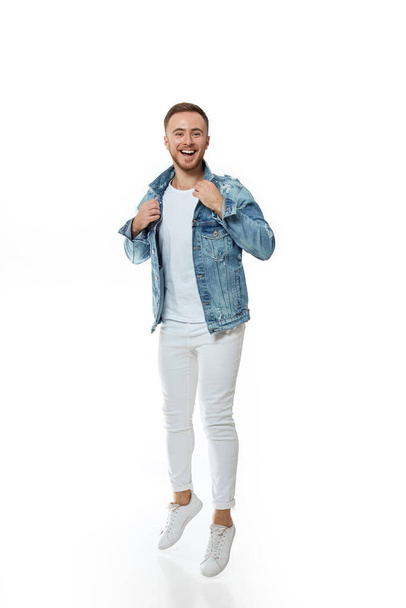 attractive crazy man in denim t-shirt jeans jump - Photo, Image