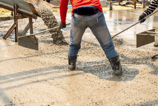 Concreter adjusting the concrete floor. - Photo, Image