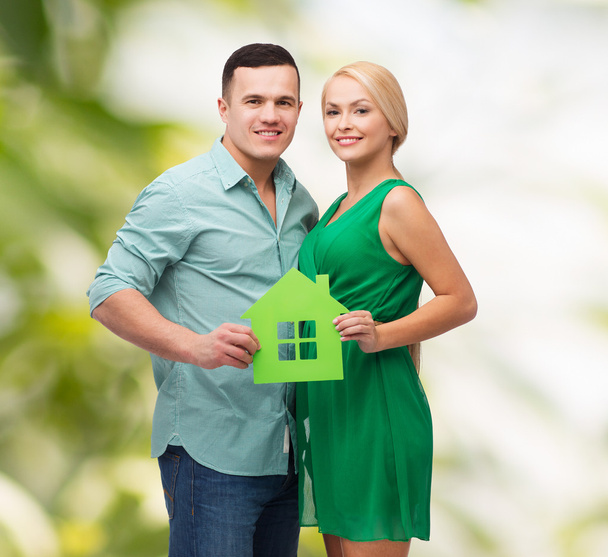 Smiling couple holding green paper house - Foto, immagini