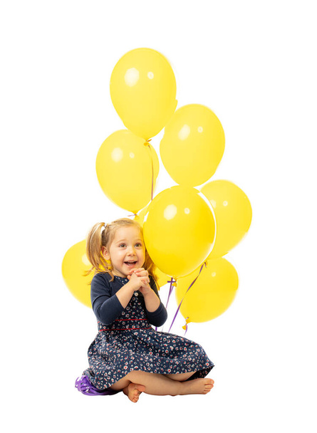3 years old blond girl with colorful balloons isolated on white background. - Zdjęcie, obraz