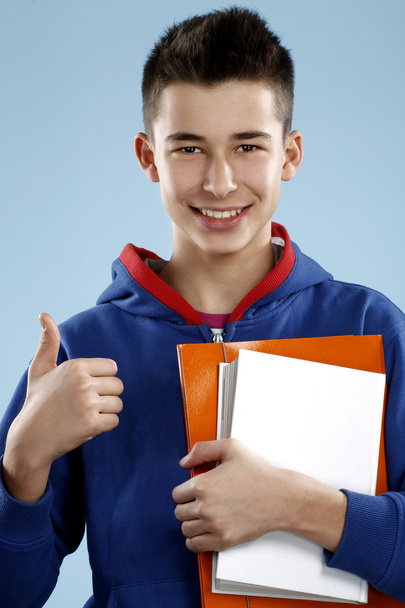 young smiling male student teenager holding a book - Foto, immagini