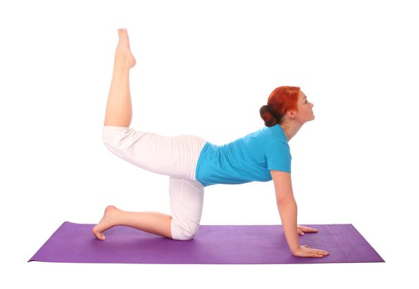 Yong woman exercise yoga pose on mat - Foto, afbeelding