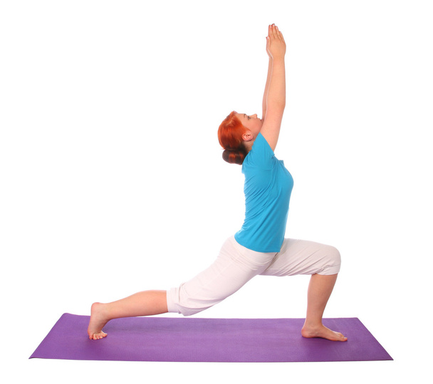 Yong woman exercise yoga pose on mat - Фото, изображение