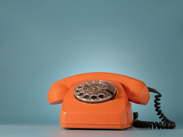 Vintage telephone on blue background - Valokuva, kuva