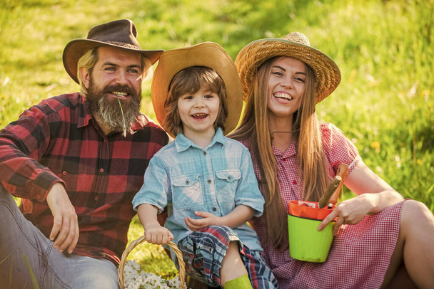 Eco life. Happy family day. Mother father and cute son. Family farm. Parents and little baby. Spend time together. Lovely family outdoors nature background. Farmers relaxing in field. Ranch concept - Foto, imagen