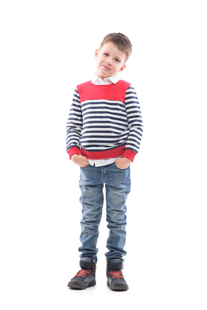 Smiling young cute boy child with hands in pockets looking at camera. Full body portrait isolated on white background.  - Photo, Image