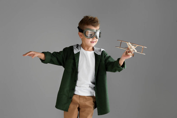 happy child boy playing with wooden toy airplane. dream - Zdjęcie, obraz