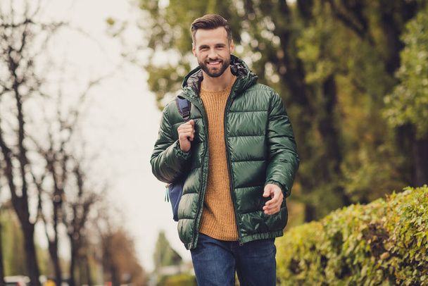 Photo of satisfied person carry bag smile look camera unzipped clothing free time walking outdoors - Photo, Image