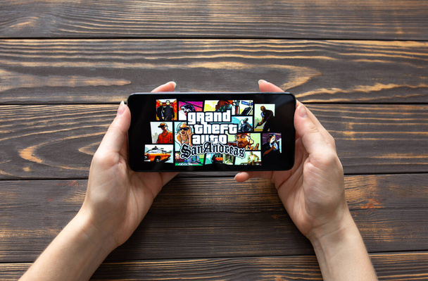 LVIV, UKRAINE - October 25, 2020 : Playing mobile game Grand Theft Auto on modern smartphone. - Foto, Bild