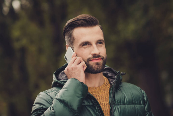 Photo of positive nice guy communicating phone look far have good mood wear warm clothing weekend outdoors - Fotografie, Obrázek