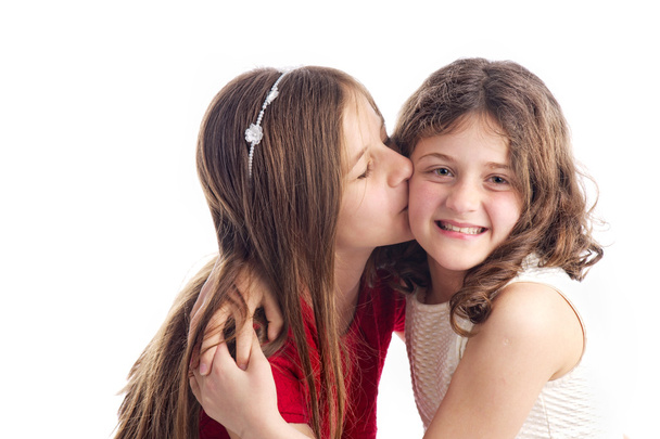 Two sisters kissing and hugging isolated on white - Foto, Imagen