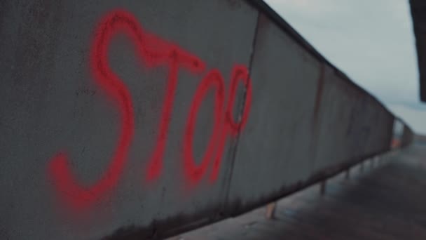 Stop signature on abandoned wall painted red spray paint - Footage, Video