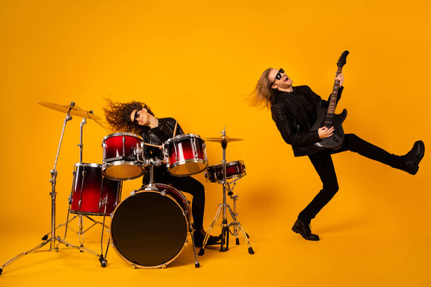 Full length photo crazy funky two people popular rock band artist play composition night club performance event guy have bass guitar solo girl drum isolated bright shine color background - Foto, Imagem