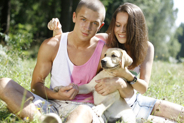 Young couple with a puppy - Zdjęcie, obraz