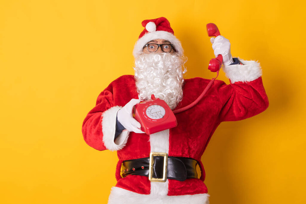 santa claus isolated on background talking on the phone - 写真・画像