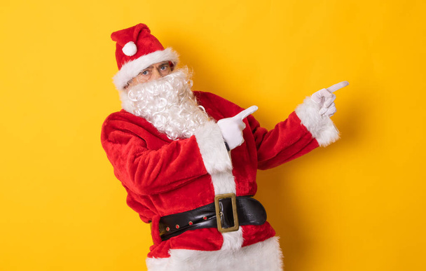 santa claus isolated on background pointing for ad or text - Foto, immagini