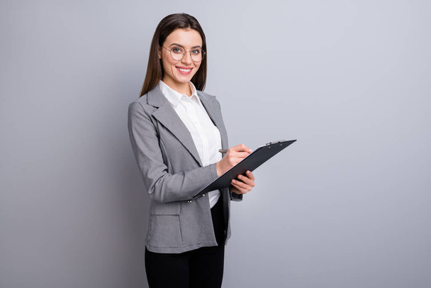 Photo of attractive business lady confident manager worker hold clipboard noting clients wishes real estate agent wear specs shirt plaid blazer isolated grey color background - Foto, immagini