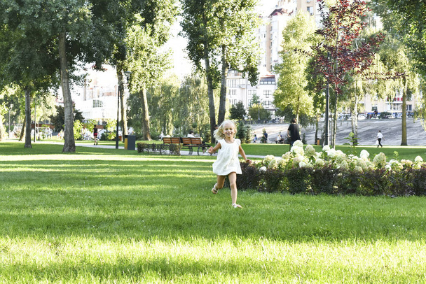 The girl is running at the park - Photo, Image