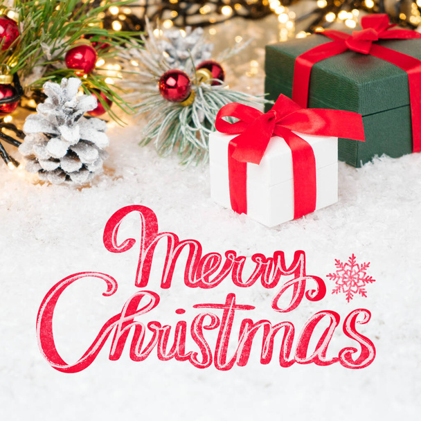 Merry Christmas greeting card with gift boxes and red ribbon on the snow. - Foto, Imagem