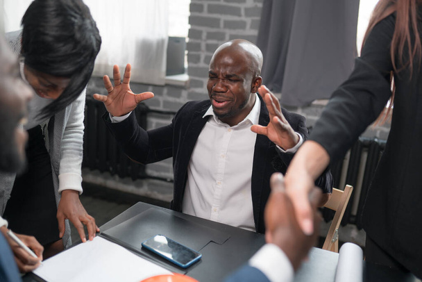 An emotional African American man is worried about the outcome of a deal with a partner. Businessman rejoices at the conclusion of a contract - Fotoğraf, Görsel