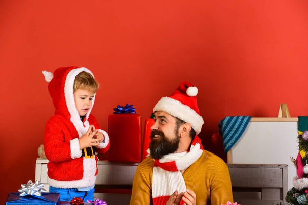 Santa and little assistant among gift boxes. - Valokuva, kuva