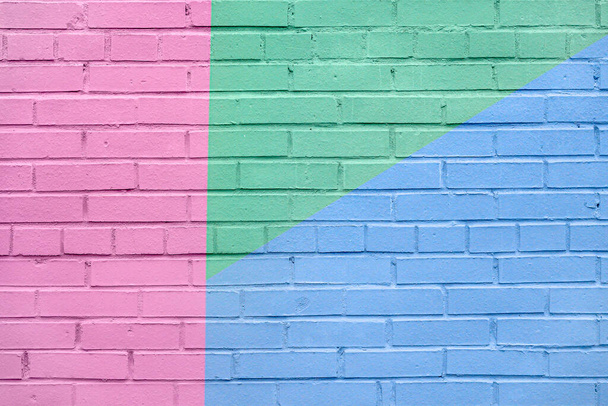 Brick wall decorated with of colorful colors. Geometric detail of a graffiti. Abstract bright background - Фото, зображення