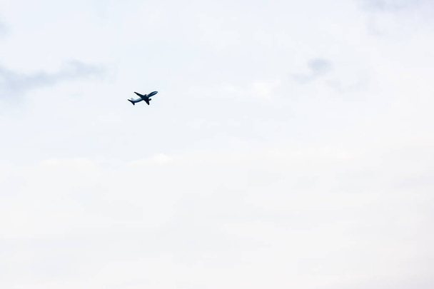 The plane rises to the sky gaining altitude against light sky in the afternoon - 写真・画像