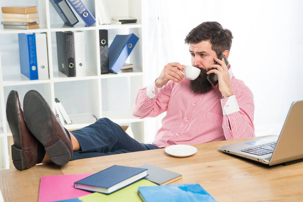 Employee drink cup of tea talking on mobile phone in modern office, technology - Photo, Image