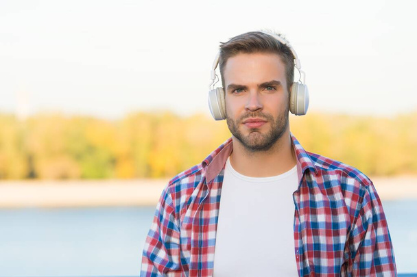 Distant Education. music style. elearning concept. quality of sound. innovative wireless device. unshaven guy with ear stereo headphones. male casual hipster fashion. man in headset listen song - Zdjęcie, obraz