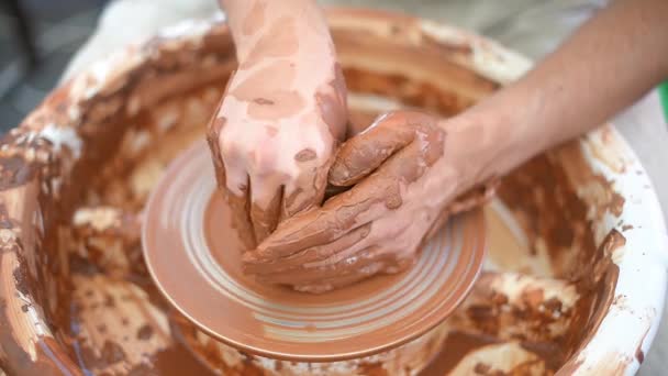Creating vase of white clay close-up. The sculptor in the workshop makes a jug out of earthenware closeup. Twisted potters wheel. Master crock. - Footage, Video