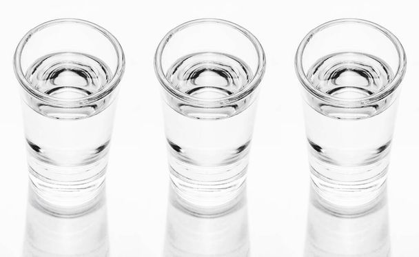 Vodka shots in a row isolated on white background - Photo, Image