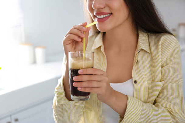 Young woman with cold kvass indoors, closeup. Traditional Russian summer drink - Фото, зображення