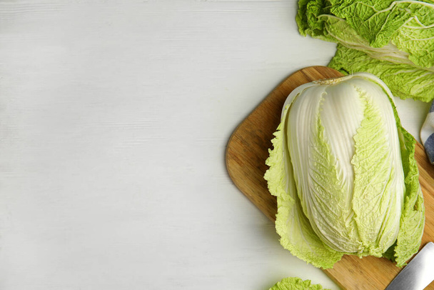 Fresh ripe Chinese cabbages on white wooden table, flat lay. Space for text - Фото, изображение