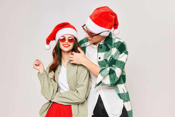 Man hugs woman New Years holiday fun dark glasses - Photo, Image