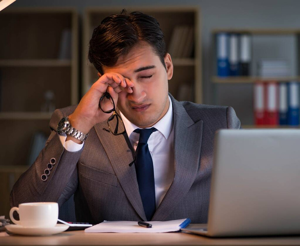 Businessman staying in the office for long hours - Foto, imagen