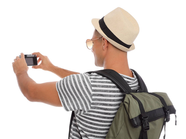 Man with straw hat taking picture on white background. Summer travel - Φωτογραφία, εικόνα