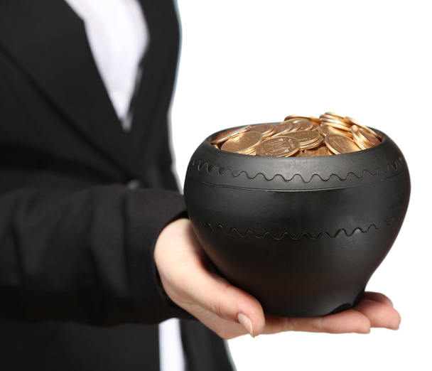 Ceramic pot with golden coins in female hands, on light background - Photo, Image