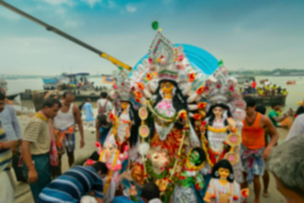 ドゥルガ女神の偶像の燃えるようなイメージは、ドゥルガ祭の終わりに、没入のためにガンジス川に運ばれています。イベントはベンガル語でBisorjonと呼ばれています. - 写真・画像