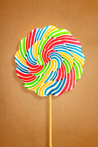 Colorful retro style lollipop isolated on brown paper - Foto, afbeelding