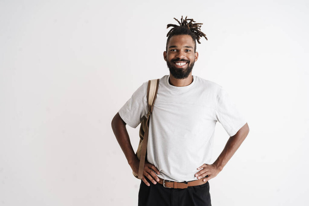Photo of joyful african american guy smiling while posing with backpack isolated over white background - Photo, Image