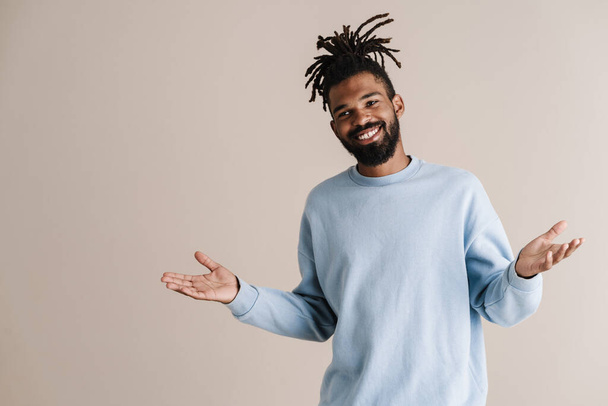Happy african american guy posing with throwing up hands isolated over white background - Zdjęcie, obraz