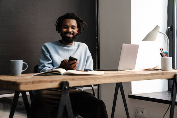 Confident young african man freelancer working at the desk - Fotó, kép