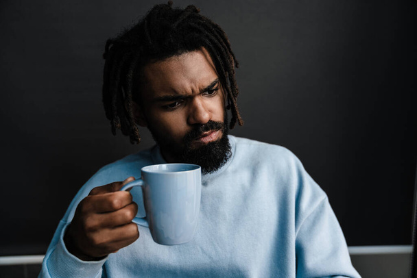 African american black serious man holding cup of coffee at home, close up - Φωτογραφία, εικόνα