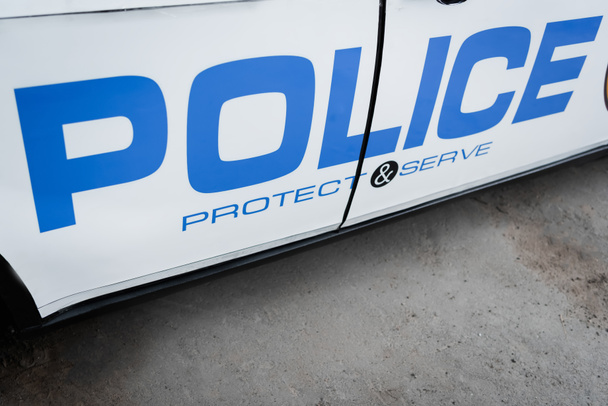 patrol car with blue police lettering outdoors - Φωτογραφία, εικόνα